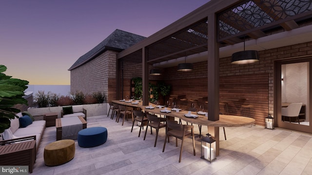 8551 Connecticut Ave Unit 210, Chevy Chase, MD 20815 - patio terrace at dusk with outdoor lounge area and exterior bar