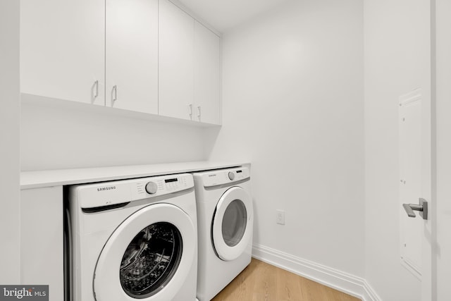 8551 Connecticut Ave Unit 210, Chevy Chase, MD 20815 - washroom with cabinets, light wood-type flooring, and washing machine and clothes dryer