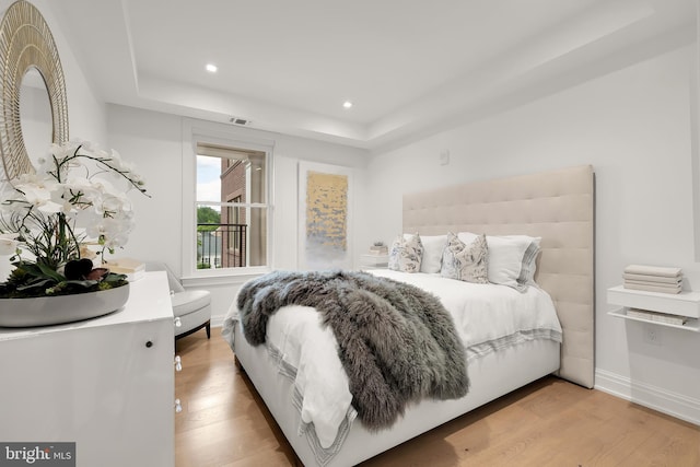 8551 Connecticut Ave Unit 210, Chevy Chase, MD 20815 - bedroom with a raised ceiling and light wood-type flooring