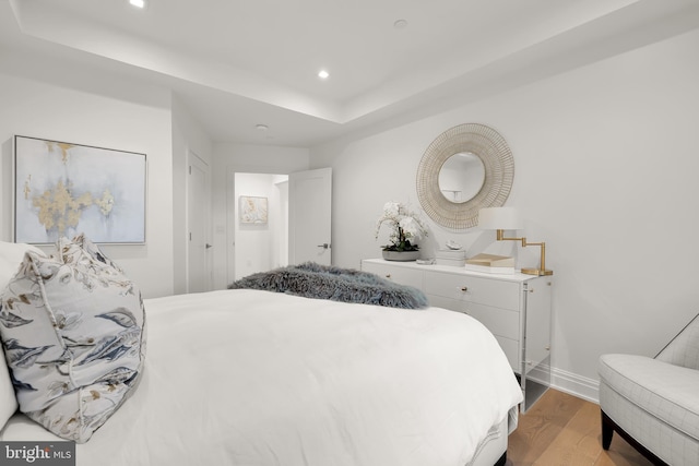 8551 Connecticut Ave Unit 210, Chevy Chase, MD 20815 - bedroom with a raised ceiling and light hardwood / wood-style flooring