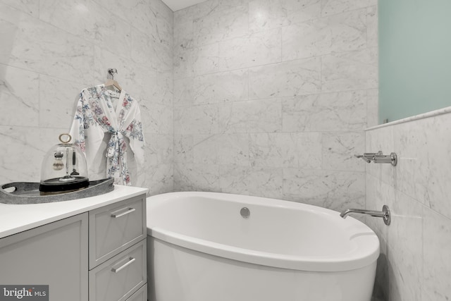 8551 Connecticut Ave Unit 210, Chevy Chase, MD 20815 - bathroom featuring a bathing tub, vanity, and tile walls