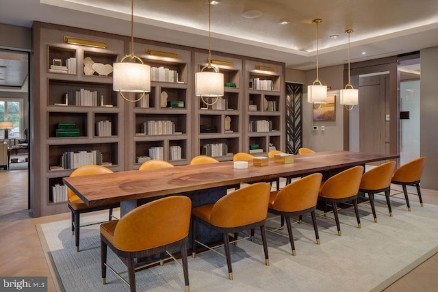 8551 Connecticut Ave Unit 210, Chevy Chase, MD 20815 - bar featuring light parquet flooring, built in shelves, hanging light fixtures, and a tray ceiling