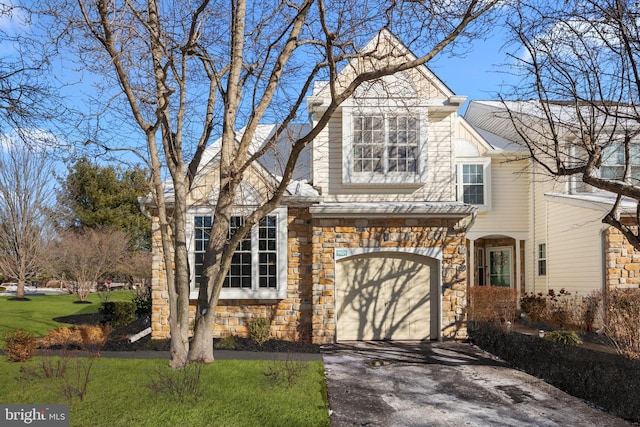 front facade with a front yard and a garage