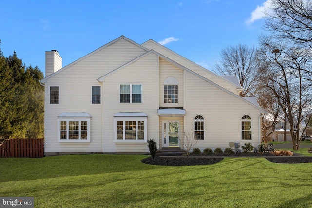 back of house featuring a yard