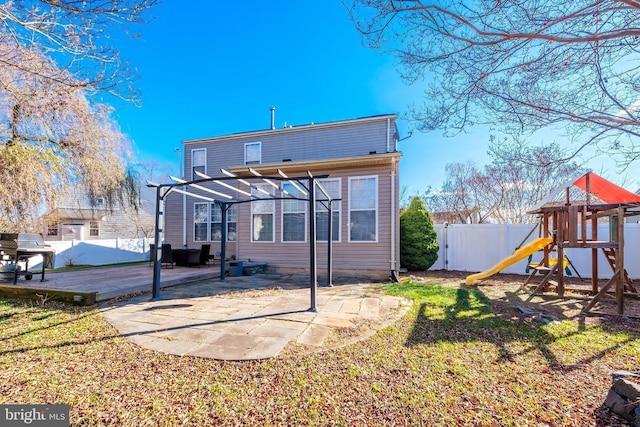 back of house with a patio area, a playground, a lawn, and a pergola