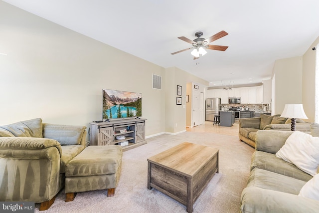 carpeted living room featuring ceiling fan