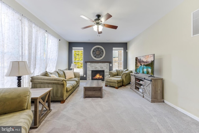 carpeted living room with ceiling fan