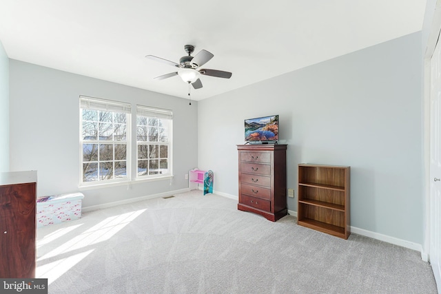 interior space with ceiling fan and light carpet