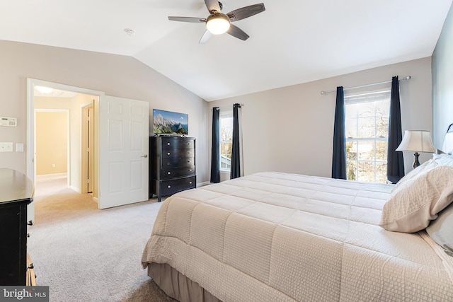 bedroom with lofted ceiling, ceiling fan, and light carpet