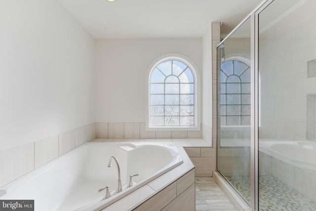 bathroom with shower with separate bathtub