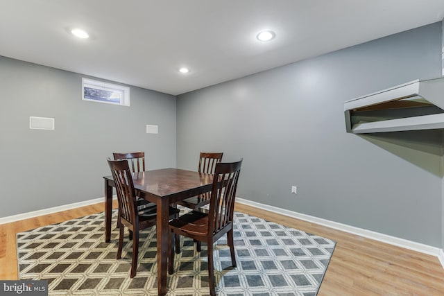 dining space with wood-type flooring