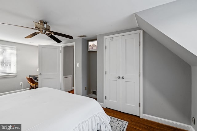 bedroom with vaulted ceiling, ceiling fan, and dark hardwood / wood-style floors