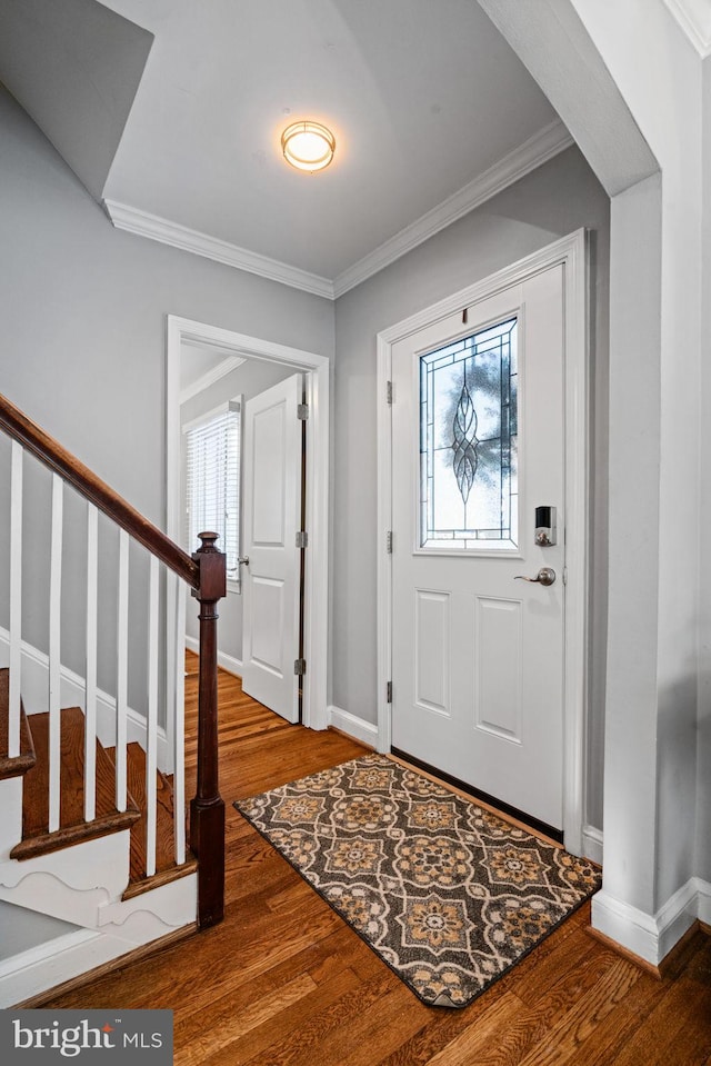 entrance foyer featuring hardwood / wood-style floors and crown molding