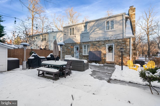 view of snow covered rear of property