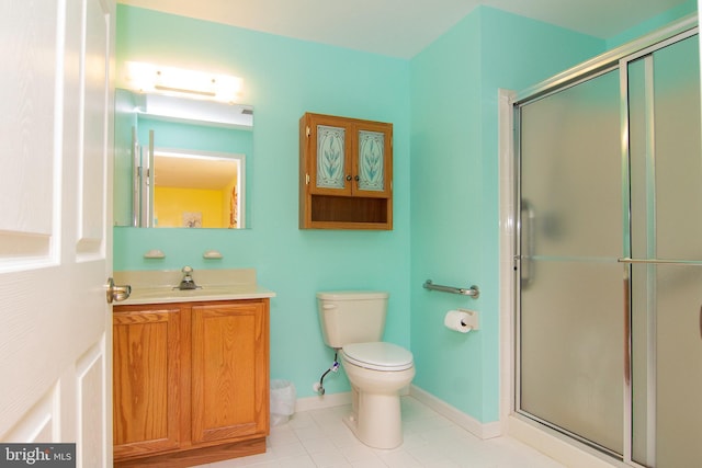 bathroom featuring tile patterned floors, toilet, a stall shower, and vanity