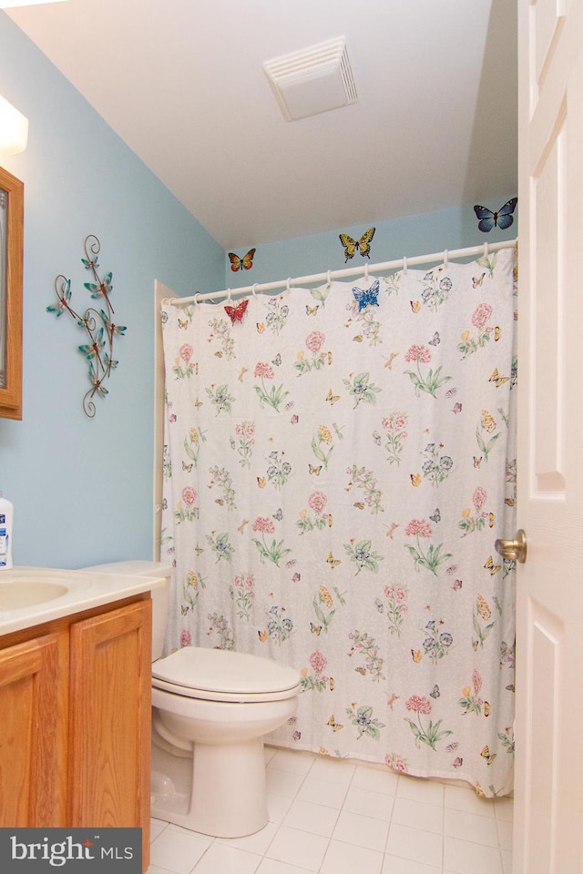 bathroom featuring vanity, toilet, and tile patterned flooring