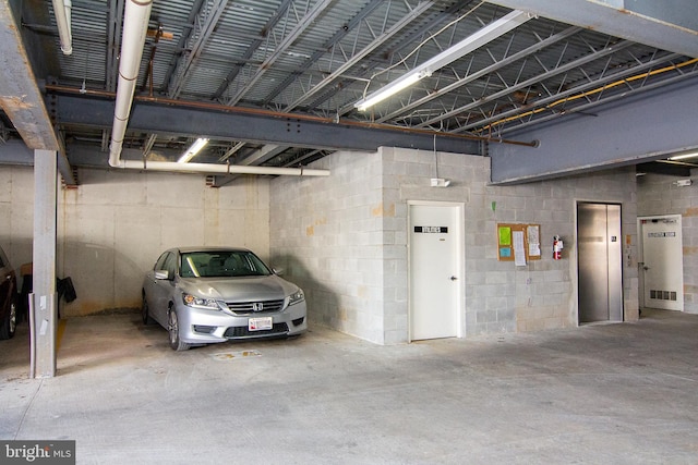 parking garage with elevator and visible vents