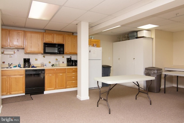 kitchen with light colored carpet, a paneled ceiling, sink, and black appliances