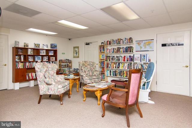 sitting room featuring carpet flooring and a paneled ceiling