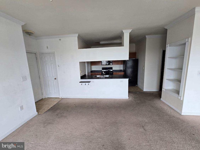 kitchen featuring kitchen peninsula, built in shelves, light carpet, and black refrigerator