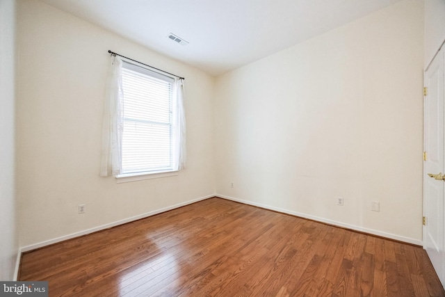 spare room with wood-type flooring