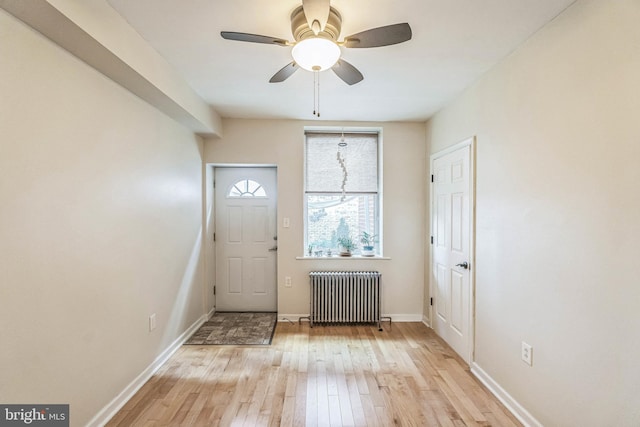 entryway featuring light hardwood / wood-style flooring, radiator, and ceiling fan