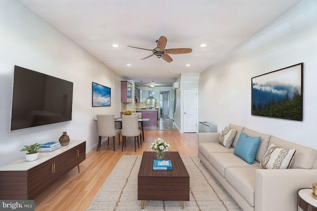 living room with ceiling fan and light hardwood / wood-style floors