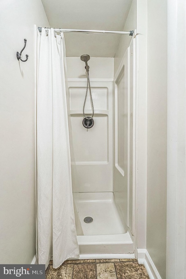 bathroom with a shower with shower curtain