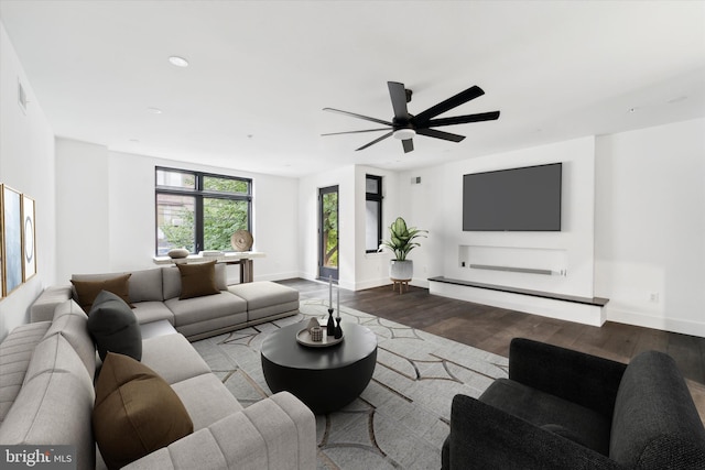 living room with ceiling fan and light wood-type flooring