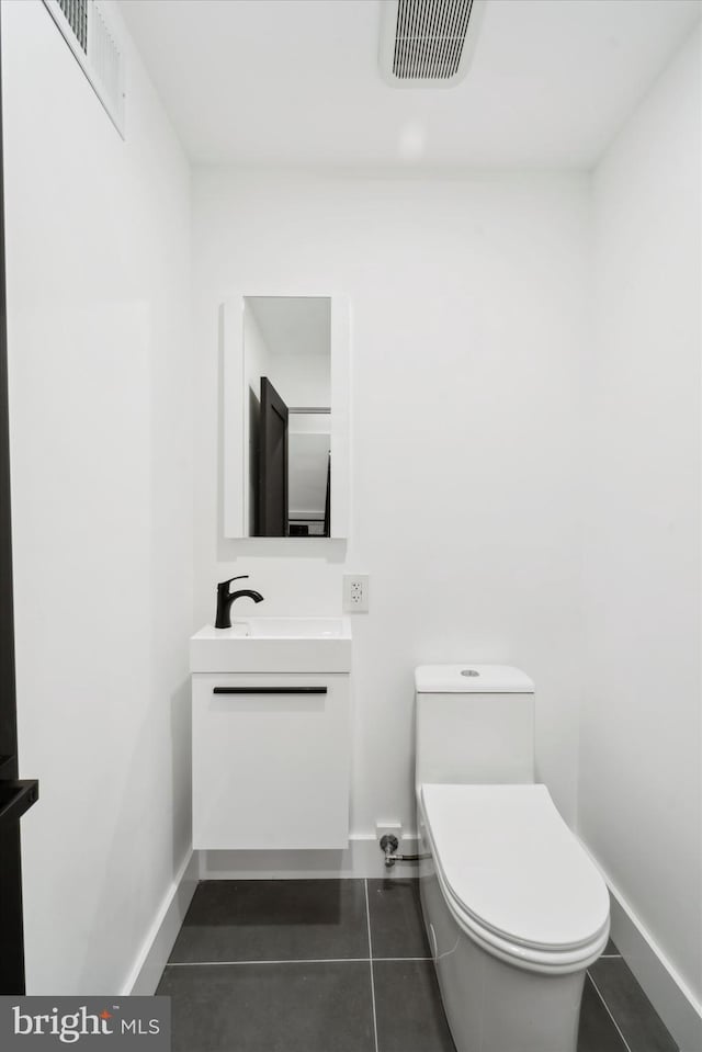 bathroom with tile patterned floors, vanity, and toilet