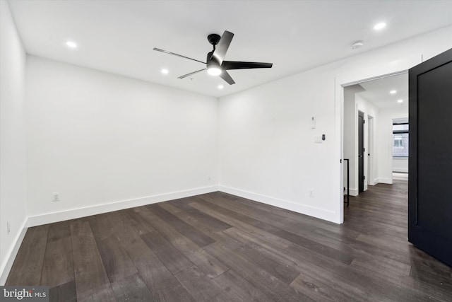 spare room featuring ceiling fan and dark hardwood / wood-style flooring