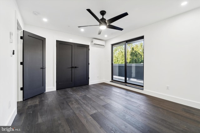 unfurnished bedroom featuring ceiling fan, dark hardwood / wood-style floors, access to exterior, and a wall mounted AC