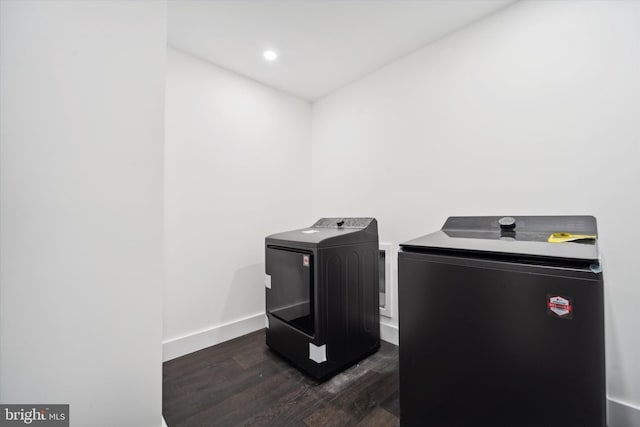 laundry area featuring washer and dryer and dark hardwood / wood-style floors