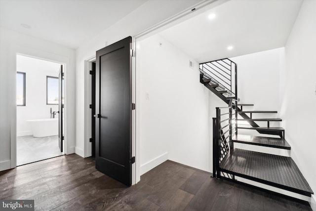 stairway featuring wood-type flooring