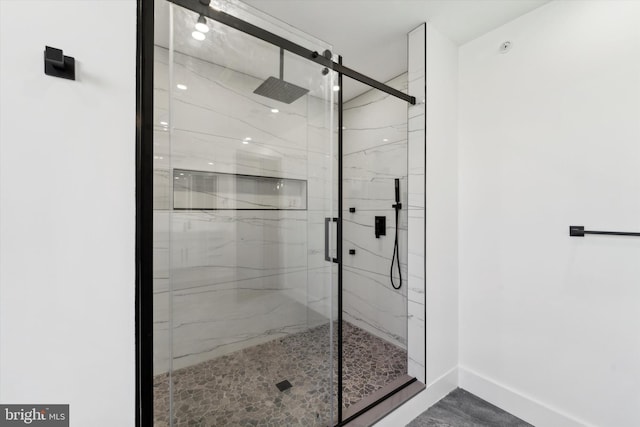 bathroom featuring a shower with door