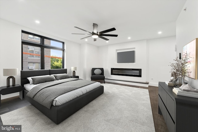 bedroom with ceiling fan and dark hardwood / wood-style floors