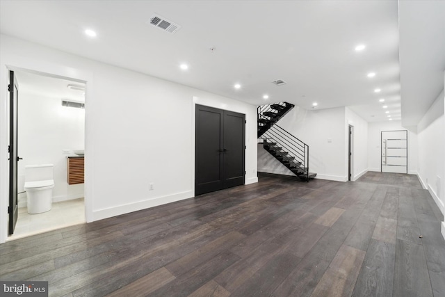 unfurnished living room featuring dark hardwood / wood-style floors