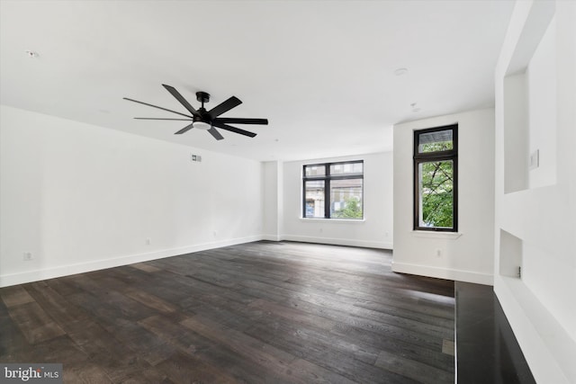 empty room featuring ceiling fan and dark wood-type flooring