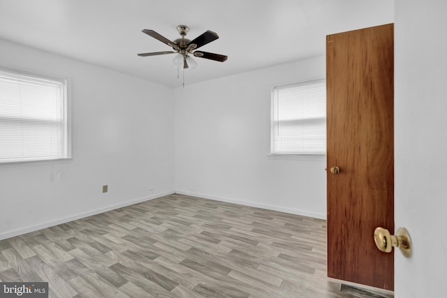 spare room featuring ceiling fan and light hardwood / wood-style floors