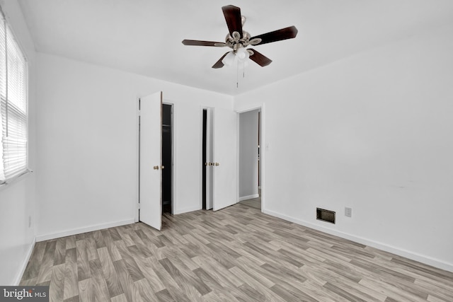 unfurnished bedroom featuring ceiling fan and light wood-type flooring