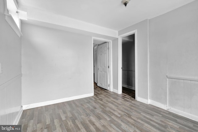 unfurnished room with wood-type flooring