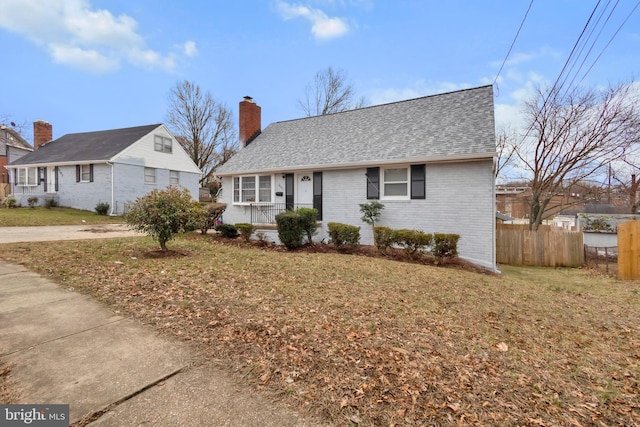 view of front facade with covered porch and a front lawn