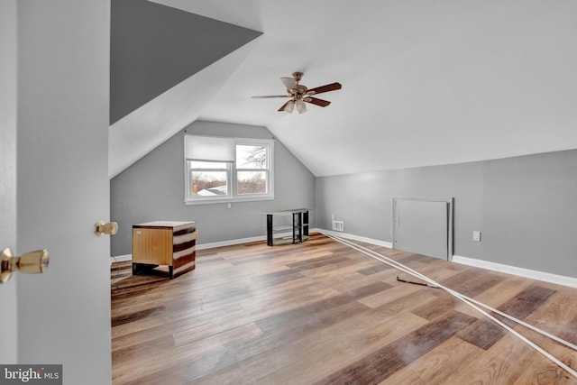 additional living space featuring ceiling fan, lofted ceiling, and light wood-type flooring