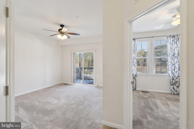 interior space featuring light colored carpet and ceiling fan