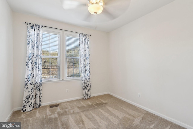 unfurnished room featuring light colored carpet and ceiling fan