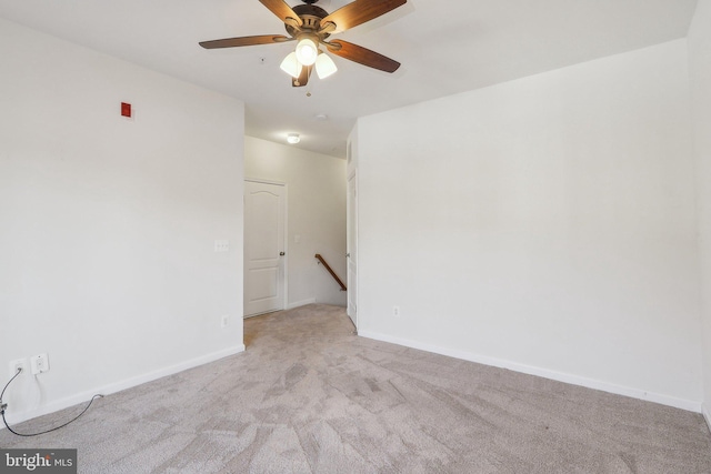 spare room with light carpet and ceiling fan