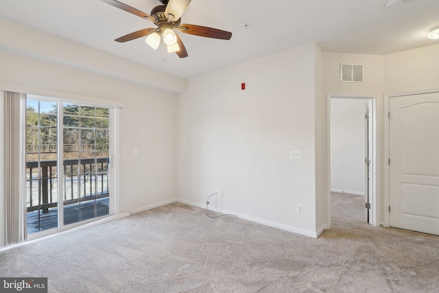 spare room featuring light colored carpet and ceiling fan