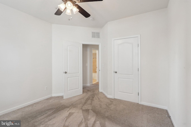 empty room with light carpet and ceiling fan