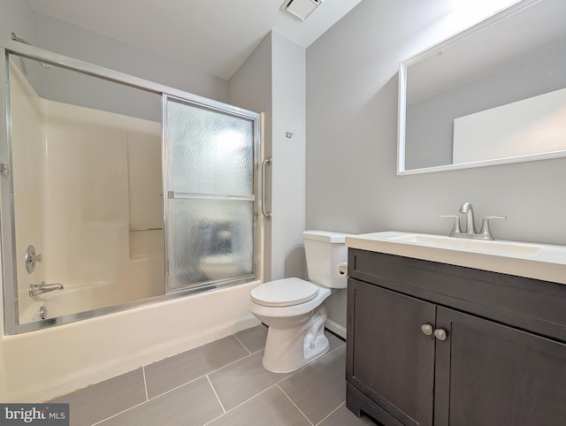 full bathroom with tile patterned floors, vanity, toilet, and enclosed tub / shower combo