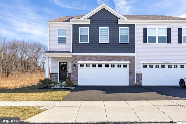 view of front facade featuring a front yard and a garage